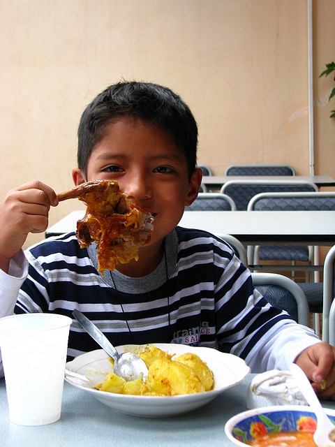 Young Man Eating Cuy